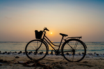 silhouette of a bicycle on the beach