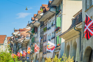 Flags among the street in the historic street in the old town of Bern, Switzerland
