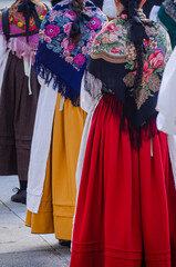 Fototapeta na wymiar partial view of women at a music event in traditional Galician costume