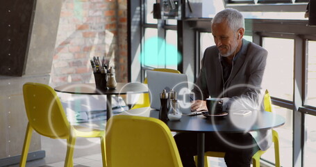 Image of icons and data processing over caucasian businessman using laptop