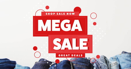 Image of mega sale text over denim trousers on white background