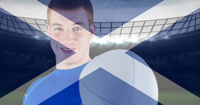 Image of flag of scotland over happy caucasian male rugby player at stadium - Powered by Adobe