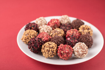 candy, plate, photography, sweet, red background, delicious, chocolate, truffle, unhealthy, food, mixed, tasty, snack, dessert, treat, sugar, cookie, cocoa,