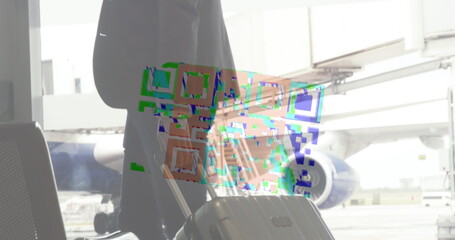 Image of a colourful QR code in a loop over biracial man carrying his suitcase, walking on an airp