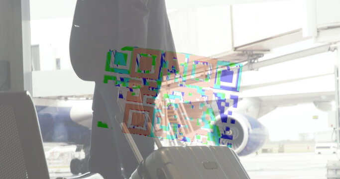 Image of a colourful QR code in a loop over biracial man carrying his suitcase, walking on an airp