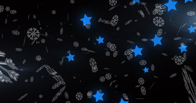 Naklejki Image of snow falling over blue glowing stars