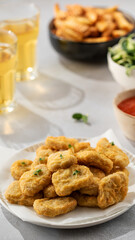 There is a plate of crispy chicken nuggets on the table. Fast food, fast food restaurant.