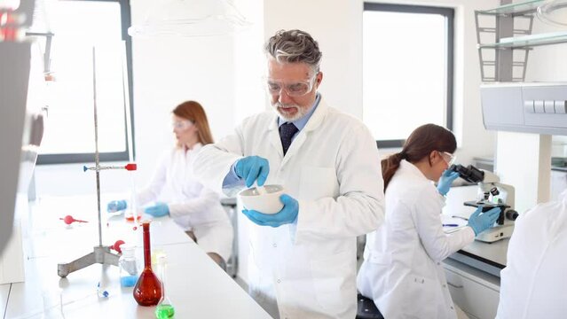 Mature specialist working at the lab