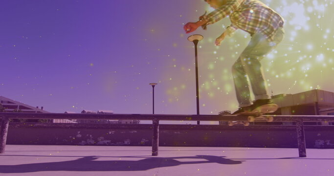 Image of light spots over caucasian man skateboarding - Powered by Adobe