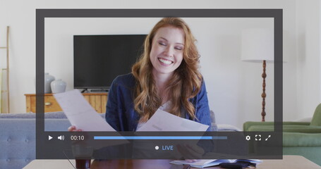 Image of financial data processing over caucasian businesswoman recording vlog