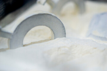 White polyamide powder and object on 3D printed from white polyamide powder close-up. Polyamide powder for creating objects on 3D printer. Additive MJF Multi Jet Fusion technologies. Thermoplastic