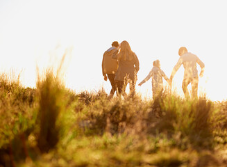 Family, nature and walk at sunset, bonding and exercise for parents and children. Lens flare,...