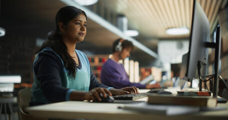Thoughtful Indian Female Student Working on Personal Development in a Quiet Public Library with...