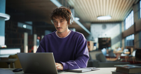 Handsome Student Writing an Essay on Laptop Computer, Thinking About the Topic, Brainstorming,...