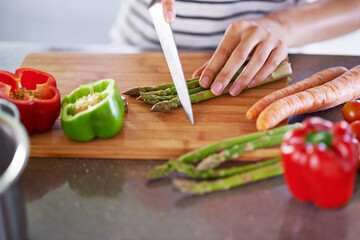 Chopping, healthy and cooking in home kitchen, organic food or meal prep with fresh produce. Diet, nutrition and cutting board for wellness ingredient, pepper asparagus or carrot in vegan lunch snack