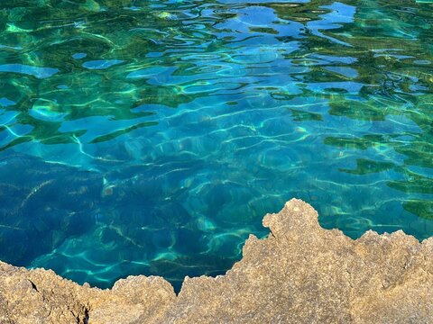Turquoise blue sea and coastal rocks.