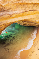 Benagil cave in Algarve Top down view.  Beautiful sandy beach with turquoise water and kayak....