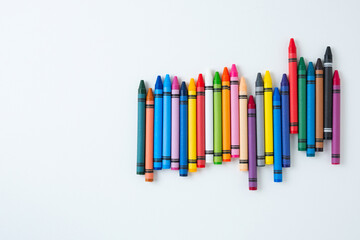 A large set of multi-colored children's wax crayons on a white background.