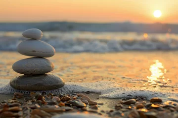 Foto auf Alu-Dibond A stack of white rocks on a beach at sunset, stability, calmness, pyramid shape © IonelV