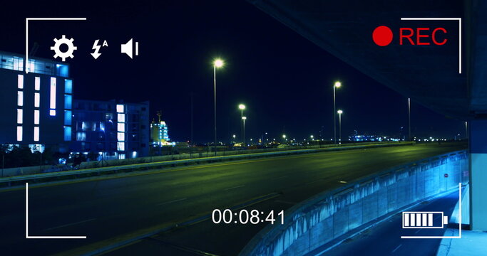 Image of night traffic in fast motion, seen on a screen of a digital camera in record mode with icon - Powered by Adobe