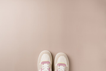 Sneakers on beige background. Space for text