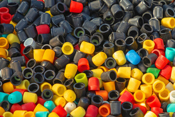 Large pile of colorful plastic valve caps sold on market outdoors - 757954786