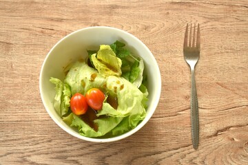 cos and tomato salad dressing Japanese sesame soy sauce on bowl