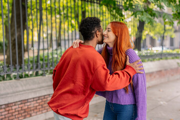 Affectionate couple embracing in a warm multiracial embrace