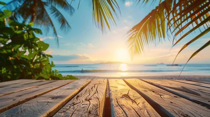 Papier Peint photo autocollant Descente vers la plage A tranquil sunset over a serene beach, viewed through the silhouette of palm leaves from a wooden boardwalk, perfect for travel and relaxation themes with a sky that allows for text.