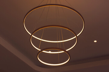 Modern ceiling lamp with three rings. Minimalism in the interior