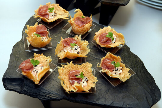 Parmesan cheese basket filled with bacon and fresh vegetables. Selective focus
