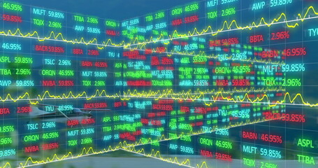 Image of trading board and graphs over airplane landing on runway