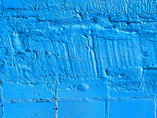 abstract blue background. the brick wall is painted with paint