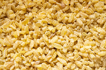 Dry bulgur wheat grains texture background. Heap of uncooked bulghur , cereal food