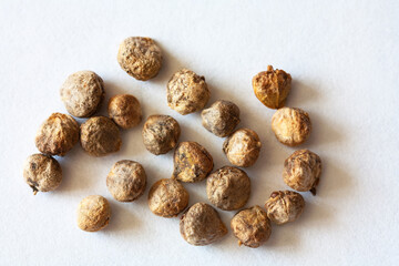 Close-up view of spinach seeds on white background. Growing fresh organic vegetables concept. White paper backdrop. Spring gardening. Macro, flat lay, top view, copy space