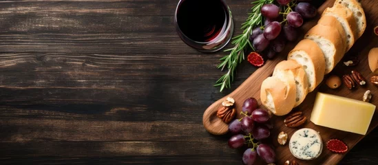 Foto op Canvas Rustic Charm: Wooden Cutting Board Spread with Bread, Cheese, Grapes, and a Glass of Wine © Ilgun