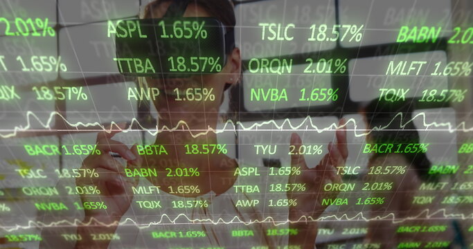 Image of financial data processing over businesswoman wearing vr headset - Powered by Adobe