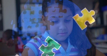 Image of puzzle pieces over biracial schoolgirlusing tablet