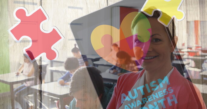 Image of autism awareness month text over diverse schoolchildren and teacher using tablet