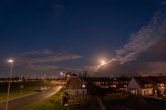A small Dutch village illuminated by the spring moon. Night story image with houses gathered together