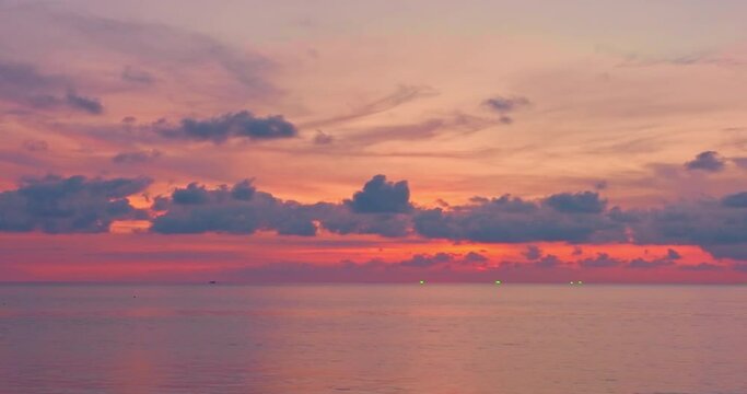 Aerial view reflection of scenery romantic sky of sunset at Karon beach..reflection amazing sky of sunset a winding canal..colorful sky background. amazing sunset over sea video 4K,4096x2160..