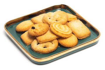 Group of assorted of danish butter cookies in a green plate isolated on white background clipping path