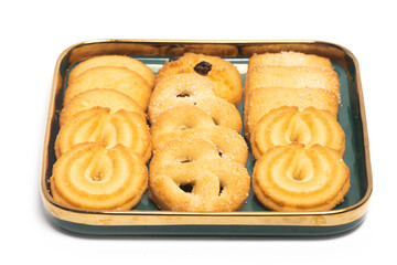 Group of assorted of danish butter cookies in a green plate isolated on white background clipping path