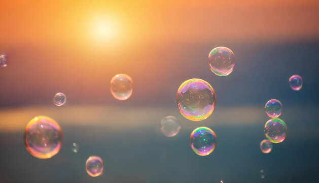 Soap bubbles floating in the air. Blurred sunset on background.