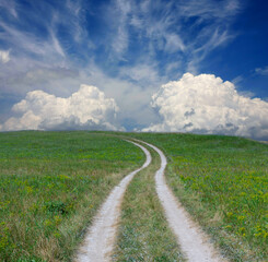road on green meadow under nice sky - 757990383