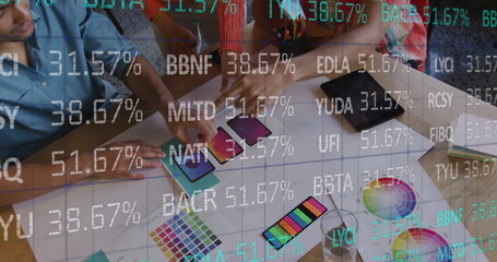 Image of stock market over diverse designers having meeting in office