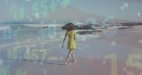 Stock market data processing against rear view of african american woman walking on the beach - Powered by Adobe