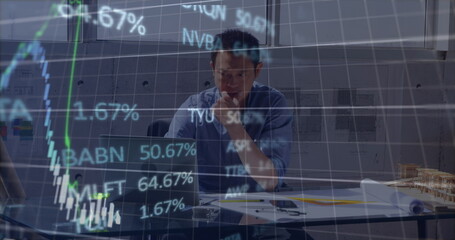 Stock market data processing over asian male engineer using laptop at office