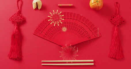 Image of chinese pattern and fan decoration on red background