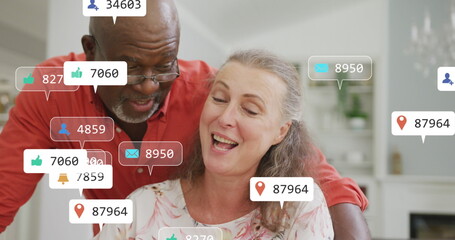 Image of social media icons and numbers over senior diverse couple at home